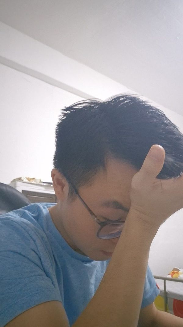 Chuan Long with his hand on his head