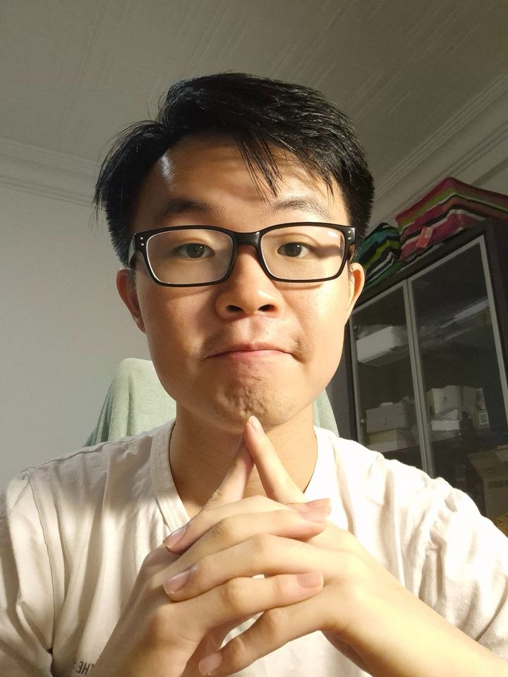 Chuan Long with his hands clasped, thinking
